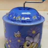 Blaue Spieldose mit fliegenden Bienen und gelben Blumen zum Kurbeln