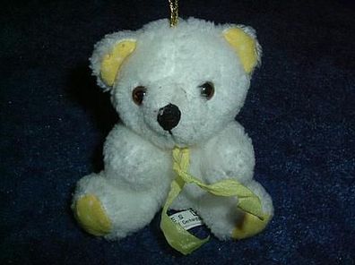 kleiner weißer Teddy mit gelber Schleife