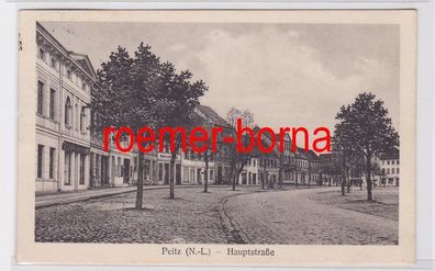 82287 Ak Peitz N.-L. (Picnjo) Hauptstraße mit Geschäften 1928
