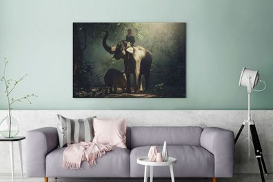 Leinwandbilder - 120x80 cm - Elefantentrainer mit einem Elefanten und ihrem Baby im W