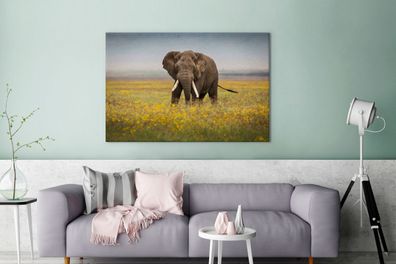 Leinwandbilder - 140x90 cm - Weidender Elefant in einem Blumenfeld (Gr. 140x90 cm)