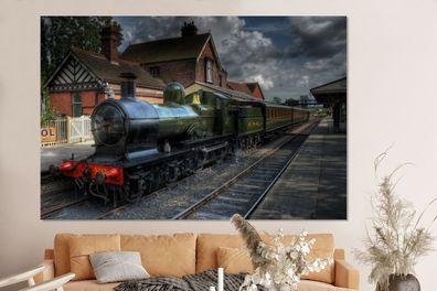 Glasbilder - 150x100 cm - Eine Dampflokomotive in einem malerischen Dorf