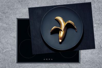 Herdabdeckplatte - 70x52 cm - Goldene Banane auf einem dunklen Hintergrund