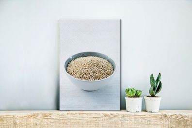 Leinwandbilder - 20x30 cm - Eine Porzellanschale voller Quinoa-Körner auf einem weiße