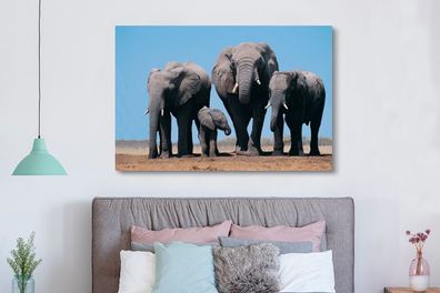 Leinwandbilder - 150x100 cm - Vier Elefanten unter einem blauen Himmel