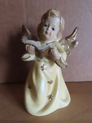 Figur Engel gelbes Kleid mit goldfarbenen Sternen Buch in der Hand Keramik